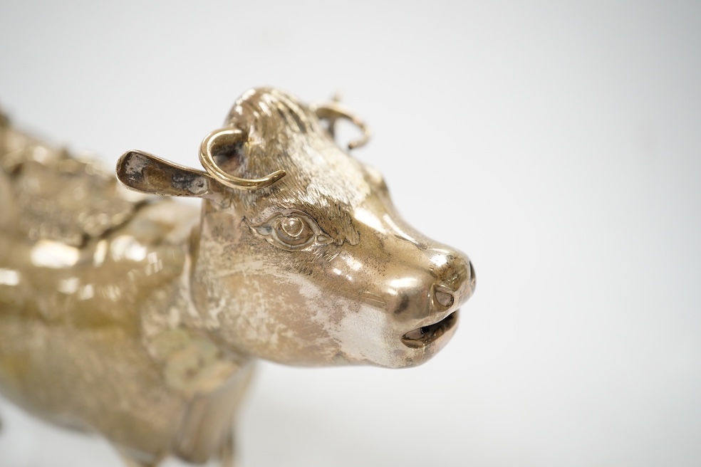 An Elizabeth II silver cow creamer, William Comyns & Sons Ltd, London, 1968, length 15cm, 14 grams. Condition - fair to good